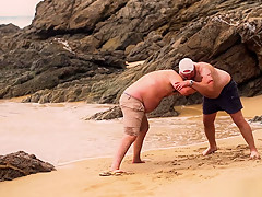 Men Wrestling On The Beach